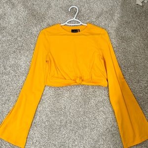 URBAN OUTFITTERS OUT FROM UNDER LONG SLEEVE CROPPED SHIRT.